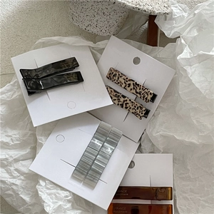 Detail view showing acetate geometric hair clips with France Handmade lettering