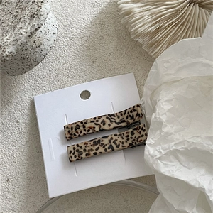 Detail view of two tortoiseshell acetate hair clips with France Handmade engraving