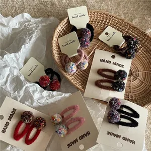 Colorful plush ball hair clips and elastic ties set on handmade display cards