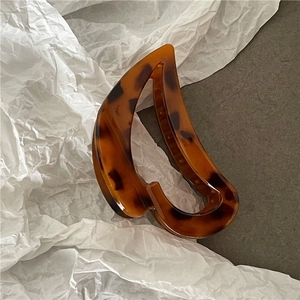 Macro shot of French hollow heart hair claw with vintage amber tortoiseshell pattern