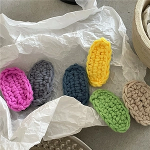Macro shot of handmade knitted BB hair clips in six pastel colors with woolen texture