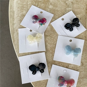 Iridescent butterfly acetate hair clips with marble texture on branded display cards