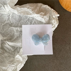 Detailed shot of light blue acetate butterfly hair clip with marble texture and rhinestones