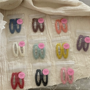 Set of 10 colorful plush fabric drop-shaped hair clips for girls on knit background