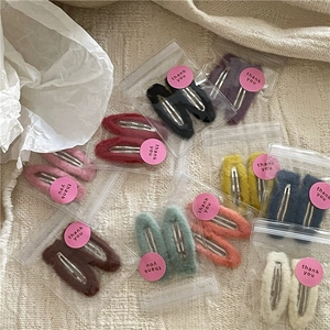 Detailed view of colorful plush water drop hair clips set in elegant gift packaging