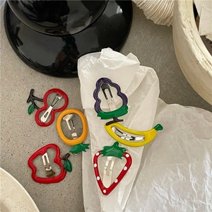 Detailed view of six colorful fruit-shaped drip oil hair clips on minimalist background