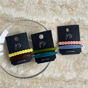 Detail view of handmade acetate geometric hair clips set on elegant display card