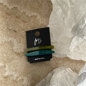 Detailed set of two acetate geometric hair clips in olive green and dark blue on card