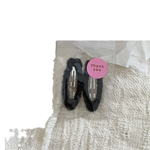 Set of two black plush drop-shaped BB hair clips in cute minimal thank you packaging