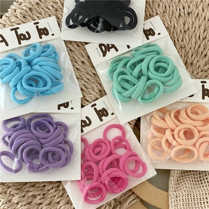 Detail of multi-colored seamless elastic hair ties in assorted cream and pastel tones