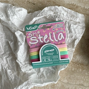 Close-up of five colorful high-elasticity cream hair ties on textured paper