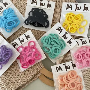 Set of colorful elastic hair ties in pastel tones for children presented on a tray