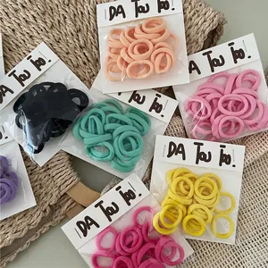 Set of colorful cream-colored mini hair ties in elastic seamless towel ring style