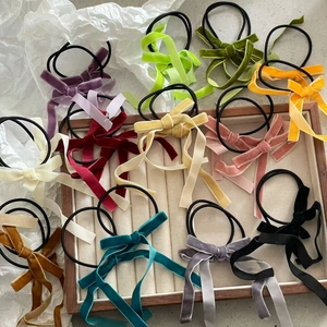 Detail of colorful velvet long ribbon bow hair scrunchies in various vibrant colors