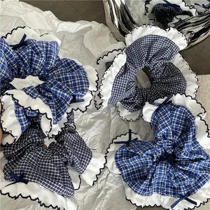 Blue plaid scrunchies with white ruffle lace and ribbon bows for women's ponytails