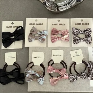 Colorful plaid and floral bow hair ties and clips set on decorative card packaging
