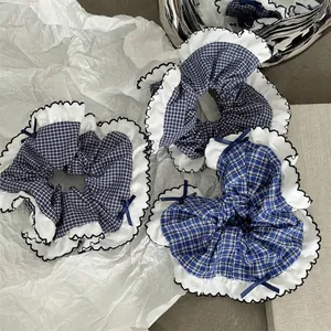 Three-piece blue and white plaid scrunchies set with lace trim and navy bows