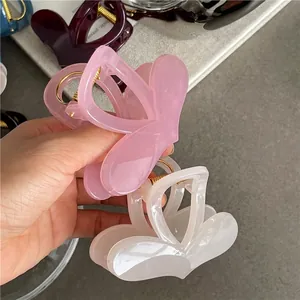 Set of two colorful heart-shaped hair claws in pink and off-white jelly texture
