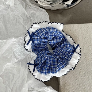 Blue plaid scrunchie with white ruffled edges and delicate dark blue ribbon bows