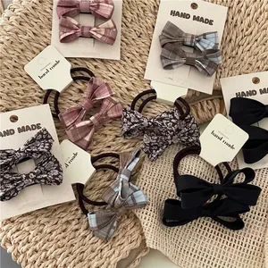 Floral and plaid bow hair accessory set with scrunchies and clips on display cards