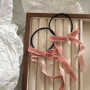 Detail of pink velvet bow hair ties in two-piece set showing premium soft fabric texture