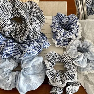Plaid and striped hair scrunchies with delicate white lace trim in a vintage aesthetic