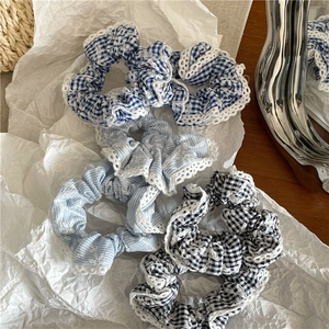 Three-piece set of plaid and striped fabric scrunchies with white lace embroidery detail
