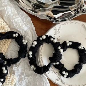 Elegant black scrunchies with white faux pearls and silky fabric for hair styling