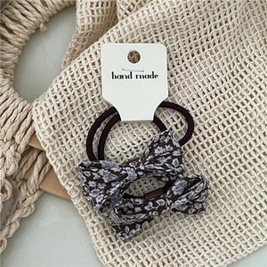 Detail of floral plaid bow hair ties on a handmade card for spring ponytail styling