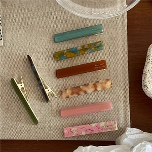 Set of colorful acetate hair clips with marble texture and golden handmade lettering
