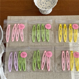 Close-up of pastel matte snap hair clips set packaged in clear bags with thank you stickers