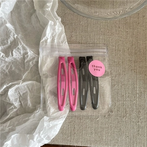 Detailed set of 4 cute pink and black teardrop hair clips in a professional thank you gift bag