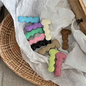 Set of colorful wave-shaped caterpillar hair clips in various bright dopamine colors