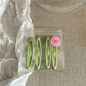 Set of four matte avocado green oval snap hair clips in elegant thank you packaging