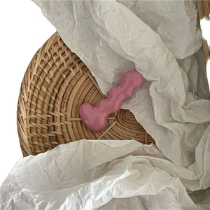 Cute pink caterpillar wavy hair clip on a natural rattan tray for a trendy girl look
