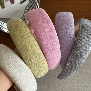 Thick padded fabric headbands in assorted pastel colors with woven texture for women