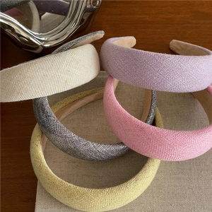Thick sponge padded headbands in cream colors with elegant linen fabric texture
