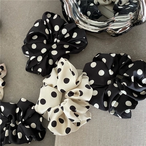 Elegant polka dot satin scrunchies in black and white colors for women hair styling