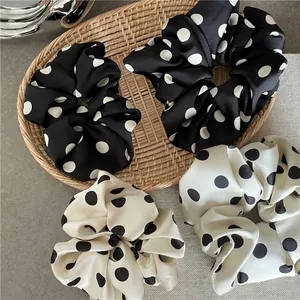 Elegant satin hair scrunchies set with black and white polka dots in French retro style