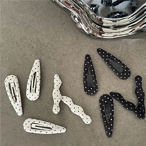 Retro black and white polka dot hair clips in teardrop and wavy shapes for women