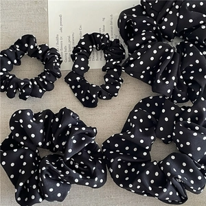 Elegant black and white polka dot scrunchie set in various sizes for stylish hair styling