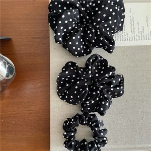 Three-piece set of black and white polka dot scrunchies in various sizes for women
