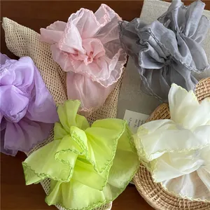 Detailed close-up of colorful organza scrunchies with translucent mesh texture and edges