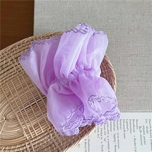 Detailed close-up of light purple mesh organza hair scrunchie with embroidery edges