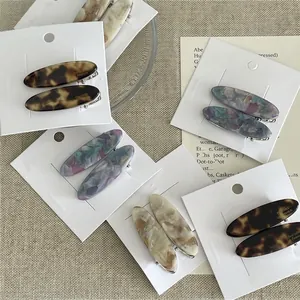 Barrettes ovales élégantes en acétate avec motifs de marbre brun et bleu marbré