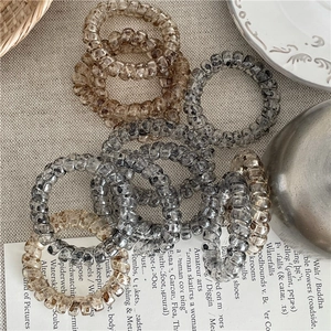 Élastiques à cheveux spirales minimalistes avec motifs léopard sur une nappe beige