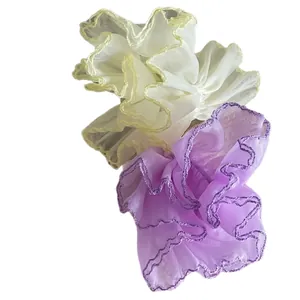 Breathable mesh organza scrunchies in pastel yellow and purple with ruffled wavy edges