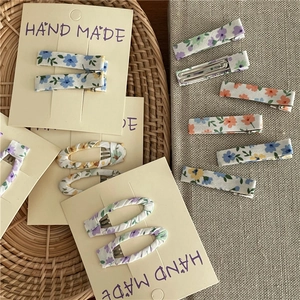 Floral fabric hair clips set with oval and rectangular shapes on handmade display card