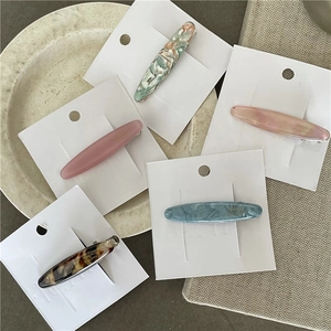 Handmade tortoiseshell and marble acetate hair clips on white card, set of five colors