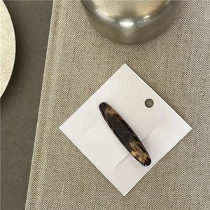Detail showing the brown acetate tortoiseshell hair clip with FRANCE Handmade engraving